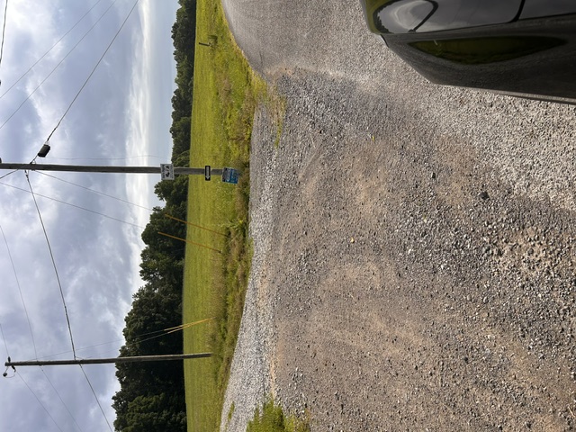 Gravel road entrance sign