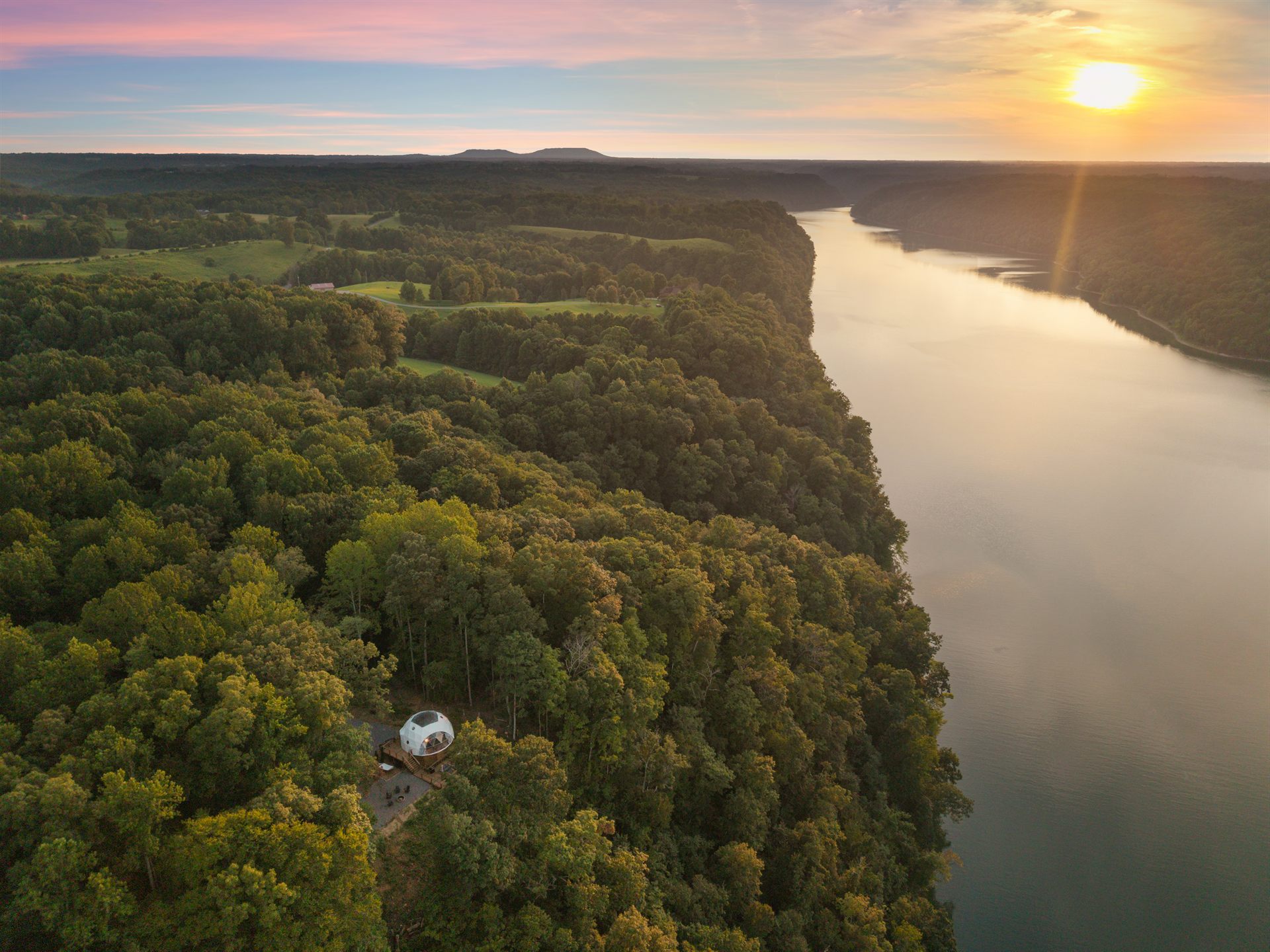 Sunset aerial view of Nestled Inn beside the lake
