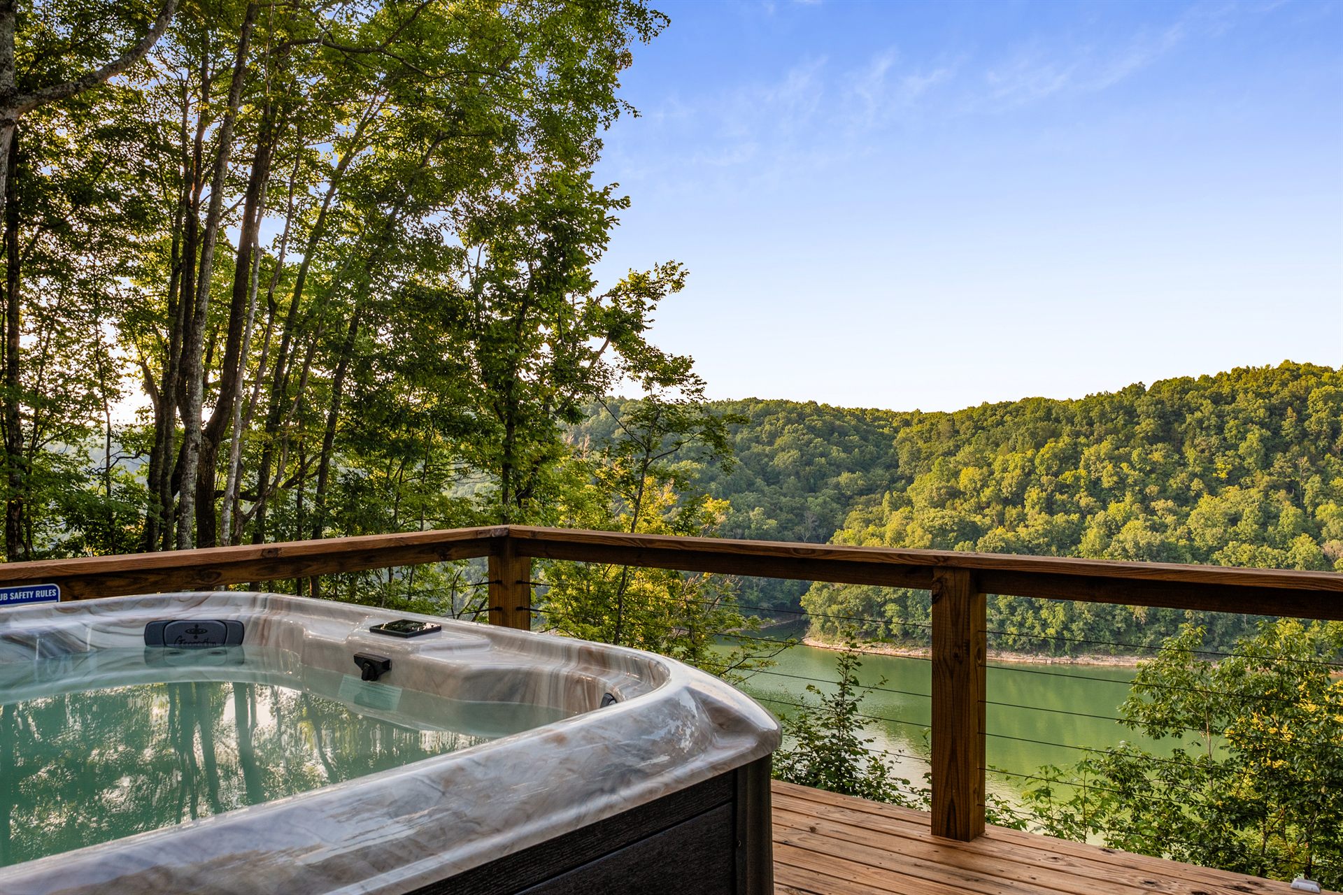 Private hot tub overlooking the lake and wooded hills
